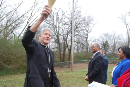 HOLLY SPRINGS – Bishop Joseph Kopacz blesses the site of what will become a volunteer house in Holly Springs for groups who come to work with Sacred Heart Southern Missions. (Photo by Laura Grisham) 