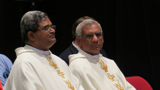 Fathers Aroika and Savio, pictured at the closing Mass, brought people from their parishes to the conference. (Photo by Rhonda Bowden)