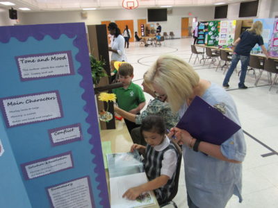 MERIDIAN – St. Patrick School hosted their first ever Reading Fair on Thursday, Jan. 19. Above, Audrey Lee explains her project to the judge, Ann Blackledge. The fair was coordinated by Jodi Lovette, teacher at St. Patrick School. First place winners move on the regional fair on February 24th. (Photo by Jennifer David)