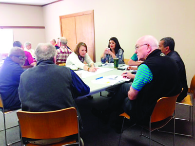 CANTON –  In bottom photo, Pam Menninger, LEM of Gluckstadt St. Joseph, gestures as she discusses goals with Father Alfred Ayem, SVD, pastor of Jackson Holy Ghost, Msgr. Elvin Sunds, pastor of Jackson St. Therese, Father Mike O'Brien, pastor of Canton Sacred Heart, Father Raul Ventura, ST, pastor of Canton Holy Child Jesus and Camden Sacred Heart and Rebecca Harris, director of Stewardship and development. (Photos by Maureen Smith)  