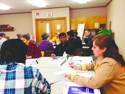 Father Xavier Jeseraj, center, works with Raquel Thompson and Sister Maria Elena Mendez. 