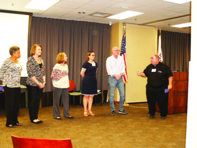 JACKSON – Father Kevin Slattery, far right, introduces resource team members (l-r) Joyce Hart, Pam Minninger, Patty Greene, Maureen Smith and Tom Walsh. (Photo by Elsa Baughman)