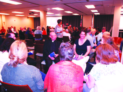 JACKSON – Members of the Cathedral of St. Peter the Apostle discuss the new mission, vision and priorities with their pastor, Father Anthony Quyet, center. (Photo by Maureen Smith)